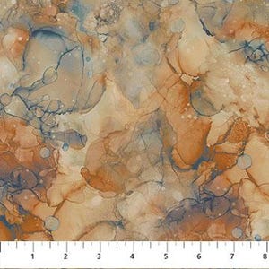 May include: Close-up of a fabric with an abstract design. The pattern features a blend of colors, including shades of brown, beige, and blue, with a marbled effect. A ruler is at the bottom, showing measurements in inches.