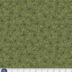 May include: A fabric swatch featuring a repeating pattern of black spiderwebs on a textured olive green background. A white ruler is visible at the bottom, showing a scale of 12 inches. The text P&B Textiles, www.pbtex.com, and HPOC 5831 G are printed.