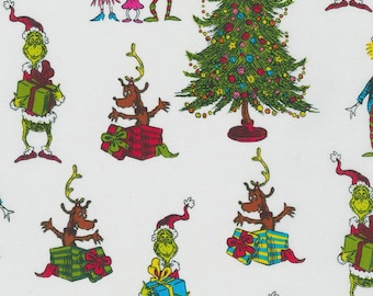 May include: White fabric featuring a repeating pattern of cartoon characters, Christmas trees, and gift boxes. The characters include a green creature in a Santa hat, a reindeer, and other figures. The Christmas tree is decorated with colorful ornaments.