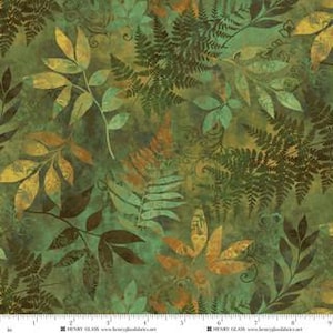 May include: A fabric swatch featuring a botanical print with dark green, olive, and golden yellow leaves and ferns on a mottled green background. A white ruler is visible at the bottom edge, showing measurements in inches up to 9 inches.
