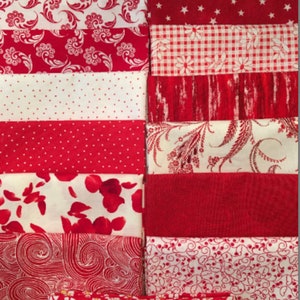 May include: A collection of red and white fabric scraps with various patterns, including floral, polka dot, and gingham. The fabrics are arranged in a vertical stack.