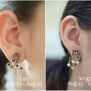 Model showcasing unique Zodiac Sign Ear Jackets. Front features a detailed zodiac sign, while the back dangles with a constellation of sparkling stars. Hypoallergenic and nickel-free, these earrings add a touch of celestial charm to any outfit.