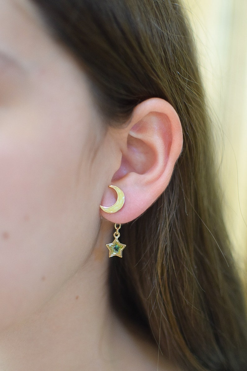 Model stylishly wearing pearl yellow crescent moon front-back earrings with a single glittery star dangling at the back. This unisex design is a chic nod to the night sky.