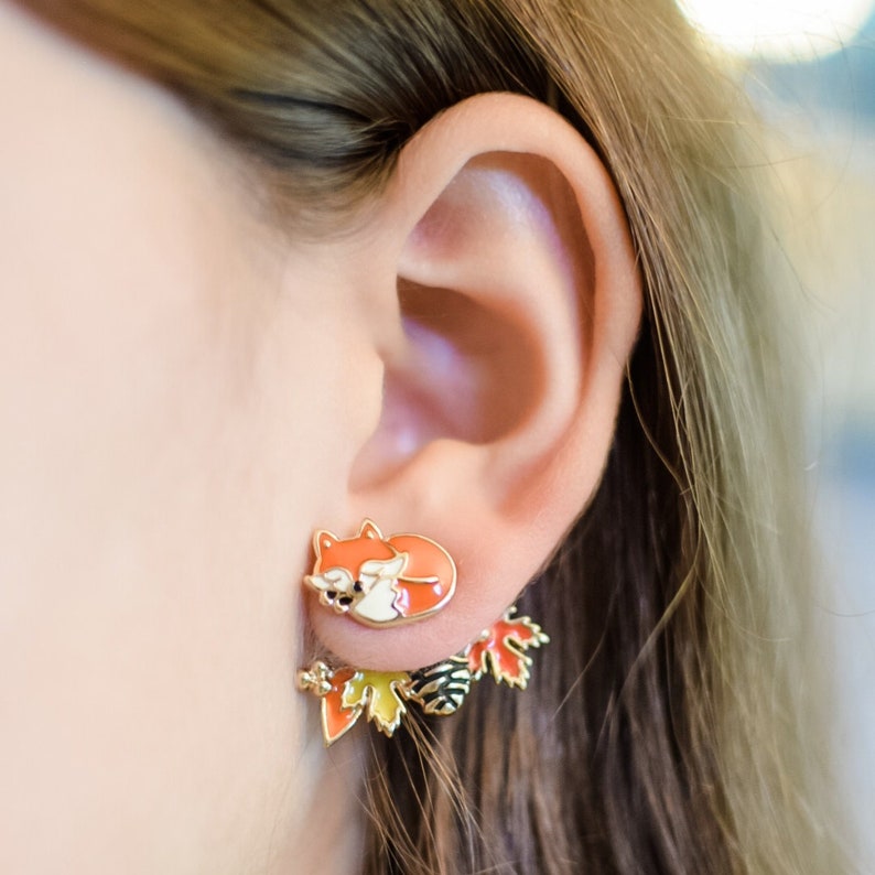 Model wearing the fall version of orange fox front back earring, showcasing how the earrings dangle.