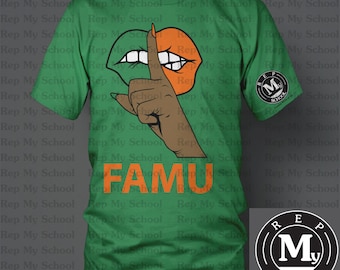May include: A green t-shirt with the words "Rep My School" repeated all over it. The shirt has a graphic of a hand with a finger over a mouth, a pair of lips, and the words "FAMU". The shirt also has a logo with the words "Rep My School" and a letter "M" in a circle.