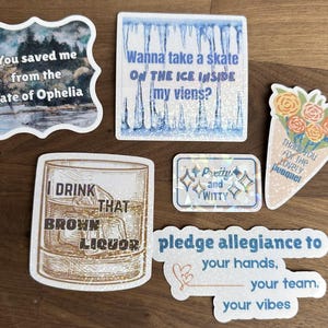 May include: A selection of decorative stickers with diverse designs and text. One sticker has a quote, another an ice skating theme, and a third says "I drink that brown liquor." Other stickers say "Pretty and Witty", "Thank you for the lovely bouquet", and "pledge allegiance to your hands, your team, your vibes."
