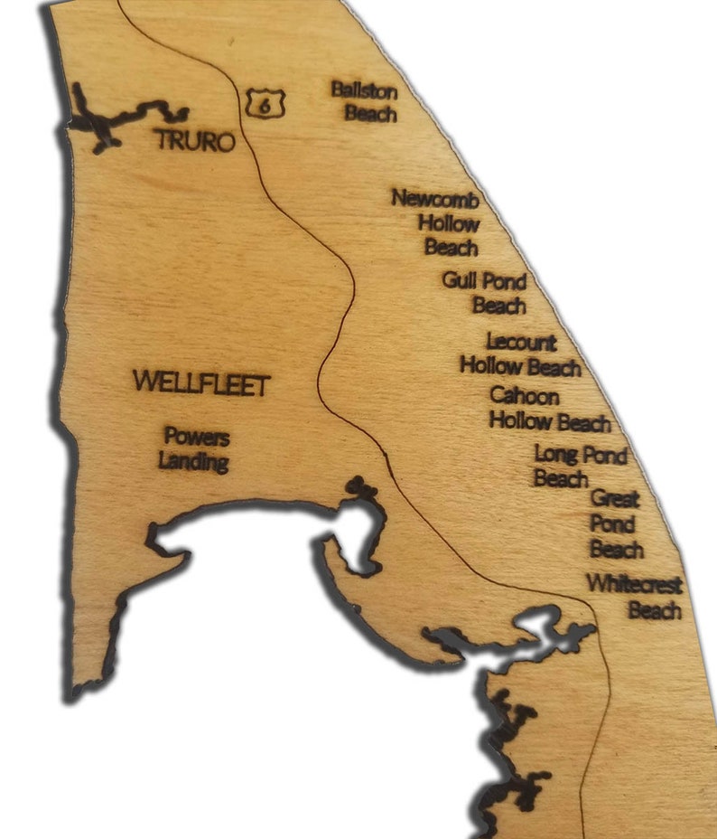 May include: A wooden map of Cape Cod, Massachusetts, with the names of various beaches and towns, including Truro, Wellfleet, Ballston Beach, Newcomb Hollow Beach, Gull Pond Beach, Lecount Hollow Beach, Cahoon Hollow Beach, Long Pond Beach, Great Pond Beach, and Whitecrest Beach.