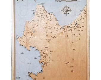 May include: A wooden map of Monterey, California, with a compass and scale in miles. The map is framed in a light wood frame and includes the text "The Davidsons Est. 09.22.18".