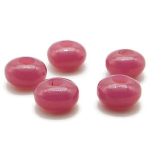 May include: Five pink glass beads with a hole in the center. The beads are round and have a glossy finish.