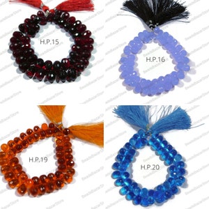 May include: Four strands of faceted gemstone beads with tassels. The beads are red, light blue, orange, and blue. The strands are labelled H.P. 15, H.P. 16, H.P. 19, and H.P. 20.