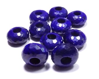 May include: Ten faceted lapis lazuli beads, each with a hole in the center, are arranged in a cluster on a white surface. The beads are a deep blue color and have a slightly iridescent sheen.