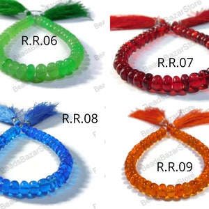 May include: Four strands of glass beads with tassels. The beads are green, red, blue, and orange. The strands are labeled R.R.06, R.R.07, R.R.08, and R.R.09.