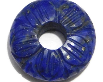 May include: A deep blue lapis lazuli bead with a carved floral design and a hole in the center.