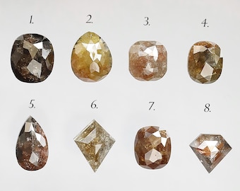May include: Eight loose diamonds of various shapes and sizes, including round, pear, and square, with a brown and gray color.