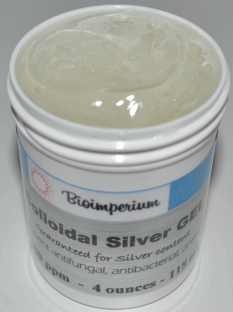 May include: A white plastic jar with a blue and white label that reads "Bioimperium Colloidal Silver Gel Guaranteed for Silver content ent antifungal, antibacterial ant Ppm - 4 ounces - 118". The jar is filled with a clear, viscous liquid.