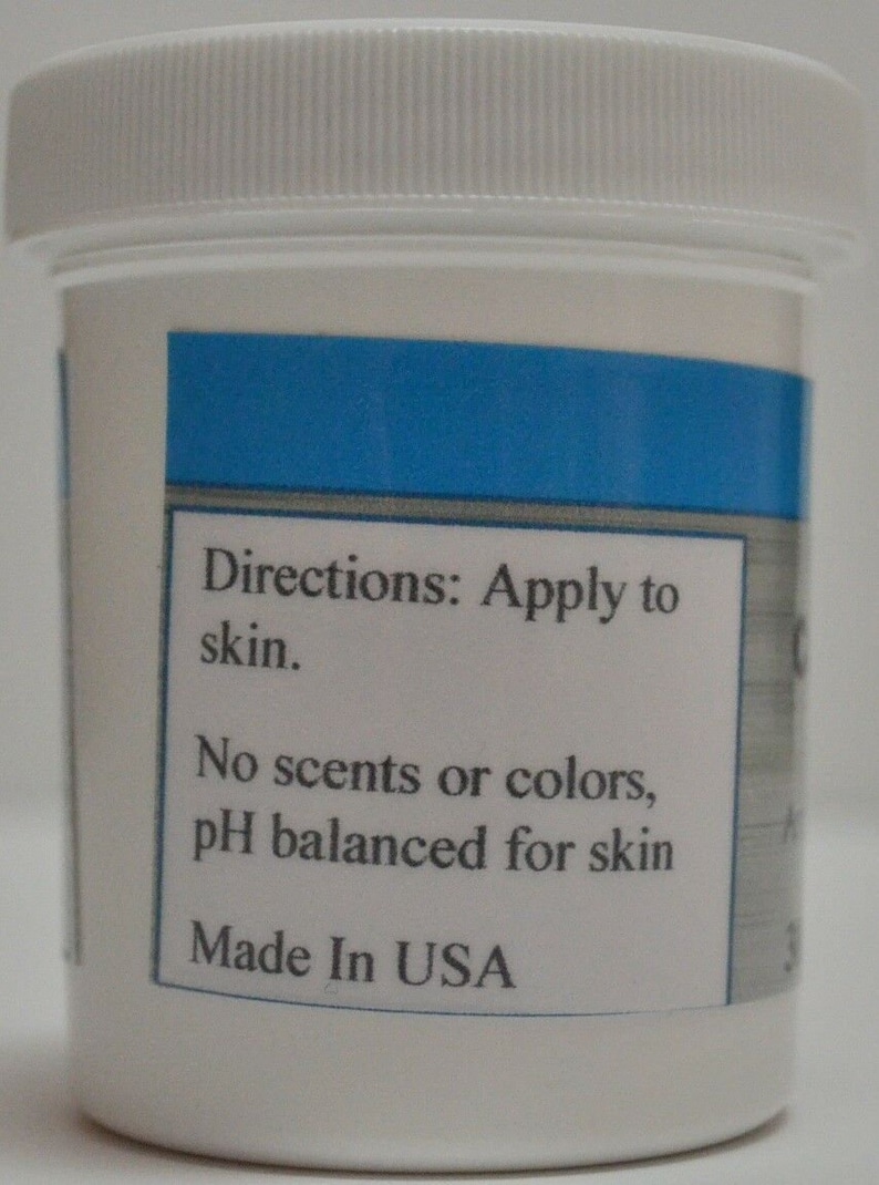May include: White plastic jar with a blue label. The label says "Directions: Apply to skin. No scents or colors, pH balanced for skin. Made in USA."