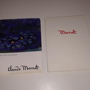 May include: Two books about Claude Monet. The front cover of the book on the left features a painting of water lilies in shades of blue and purple. The text on the front cover reads "Von Yvon Taillandier" and "Claude Monet". The front cover of the book on the right is white with the word "Monet" written in red cursive.
