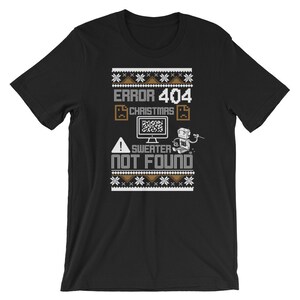 May include: Black t-shirt with a brown and white Christmas sweater design. The design features the text "ERROR 404 CHRISTMAS SWEATER NOT FOUND" with a pixelated computer screen and a robot.