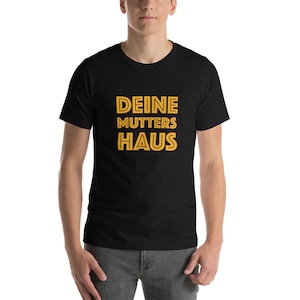 May include: A black t-shirt with the text "DEINE MUTTERS HAUS" in yellow.