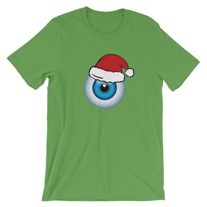 May include: A green t-shirt with a blue eye wearing a red and white Santa hat.