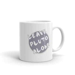 May include: White ceramic coffee mug with a purple circle and the text "LEAVE PLUTO ALONE" in white.