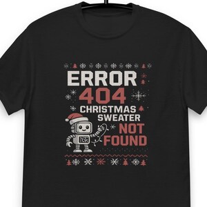 May include: Black t-shirt with a festive design. The graphic reads "ERROR 404 CHRISTMAS SWEATER NOT FOUND" with a robot wearing a Santa hat. The design includes snowflakes and Christmas trees.