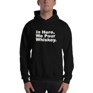 Puede incluir: Sudadera con capucha negra con texto blanco que dice "In Here, We Pour Whiskey."