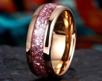 May include: A rose gold tungsten carbide ring with a pink and white inlay. The ring has a polished finish and a comfortable fit.