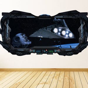 May include: A wall decal featuring a Star Destroyer and the Death Star in a space scene, framed by a dark gray, stylized cockpit window. The scene includes a planet and stars, with control panels at the bottom.