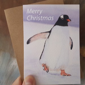 Pacote com 5 cartões de Natal, impressão em aquarela de um pinguim brincalhão, interior em branco.
