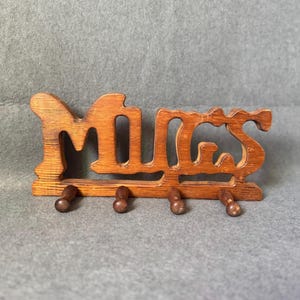 May include: A set of three ceramic mugs with a speckled, matte finish. The mugs are in shades of cream, light gray, and dark gray. Each mug has a simple, minimalist design, perfect for coffee or tea.