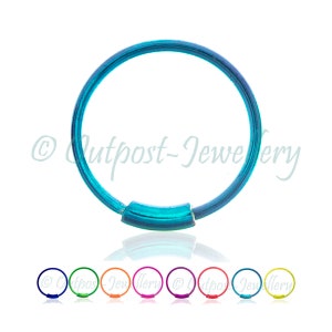May include: A teal nose ring with a hinged segment. The image shows the ring in a circular shape, with a small, curved segment that appears to be the hinge. Below the main image are smaller rings in various colours.