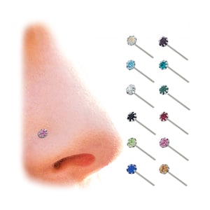 May include: Nose studs featuring a range of coloured gemstones. Each stud has a silver-coloured post and a round, faceted gemstone in colours including pink, blue, and green. One stud is shown in the nose.