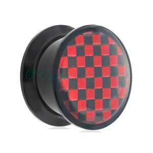 May include: Black ear gauge plug with a red and black checkered design. The plug has a rounded face and a flared edge. The checkered pattern is visible through a clear, domed surface.