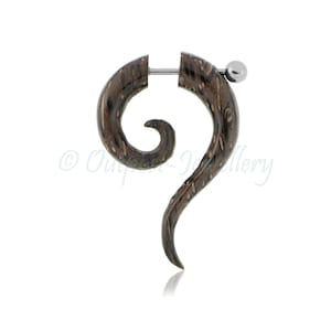 May include: A single, dark brown wooden spiral earring with a silver-coloured barbell closure. The earring has a swirling, curved design with a polished finish and a small silver ball at the end.
