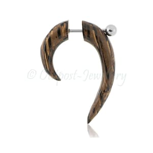 May include: A single, curved wooden earring with a dark brown and tan striped pattern. The earring has a silver-coloured post and a small ball closure. The design is a spiral shape, and the earring is shown against a white background.