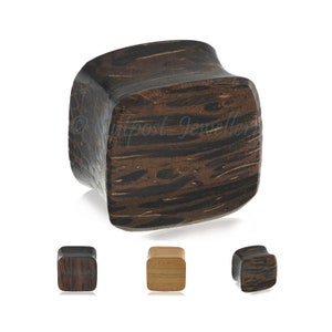 May include: Dark brown wooden ear plug with a square shape and curved sides. The wood grain is visible, with lighter and darker streaks. Three smaller plugs are shown below, in different wood tones.