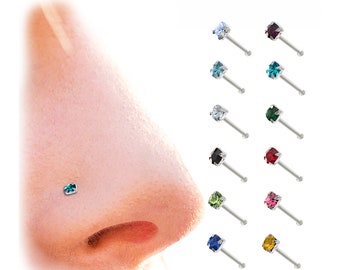 Puede incluir: Primer plano de una nariz con un piercing de nariz turquesa. A la derecha hay once piercings de nariz con piedras preciosas cuadradas de varios colores, incluyendo azul, morado, verde, transparente, negro y rojo. Los piercings tienen postes plateados.