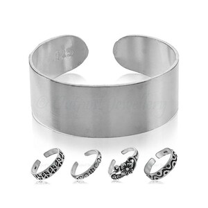 May include: A collection of silver toe rings. One is a wide band with the number "925" stamped on it. The other four rings have decorative designs, including leaves, swirls, and a flower. The rings are displayed on a white background.