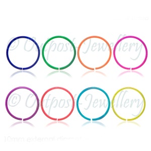 May include: Eight brightly coloured open-hoop nose rings in blue, green, orange, pink, purple, red, teal, and yellow. Each ring has a 10mm external diameter.