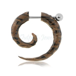 May include: A spiral earring with a brown and black pattern. The earring features a silver-coloured post and a small, round ball. The design resembles a horn or spiral. The earring is set against a white background.