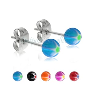 May include: A pair of stud earrings with blue, white, and green spherical beads. The earrings have stainless steel posts and butterfly backs. Additional earrings in black, orange, purple, and red are shown below.