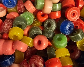 May include: A close-up of a variety of colorful skateboard wheels. The wheels are made of a hard plastic and have a variety of colors, including red, blue, green, yellow, and pink.