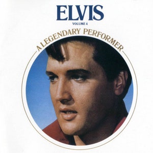 May include: A close-up portrait of Elvis Presley, in a red shirt, against a blue background. The text "Elvis" is at the top of the image, and "A Legendary Performer" is in a circle around the portrait. The text "Volume 4" is below the word "Elvis".