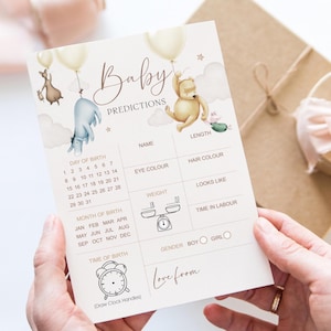 Puede incluir: Tarjeta de predicci&oacute;n para baby shower de color crema con las palabras "Baby Predictions" en escritura elegante. La tarjeta presenta ilustraciones de personajes de Winnie the Pooh y globos. Incluye secciones para nombre, color de ojos y peso.