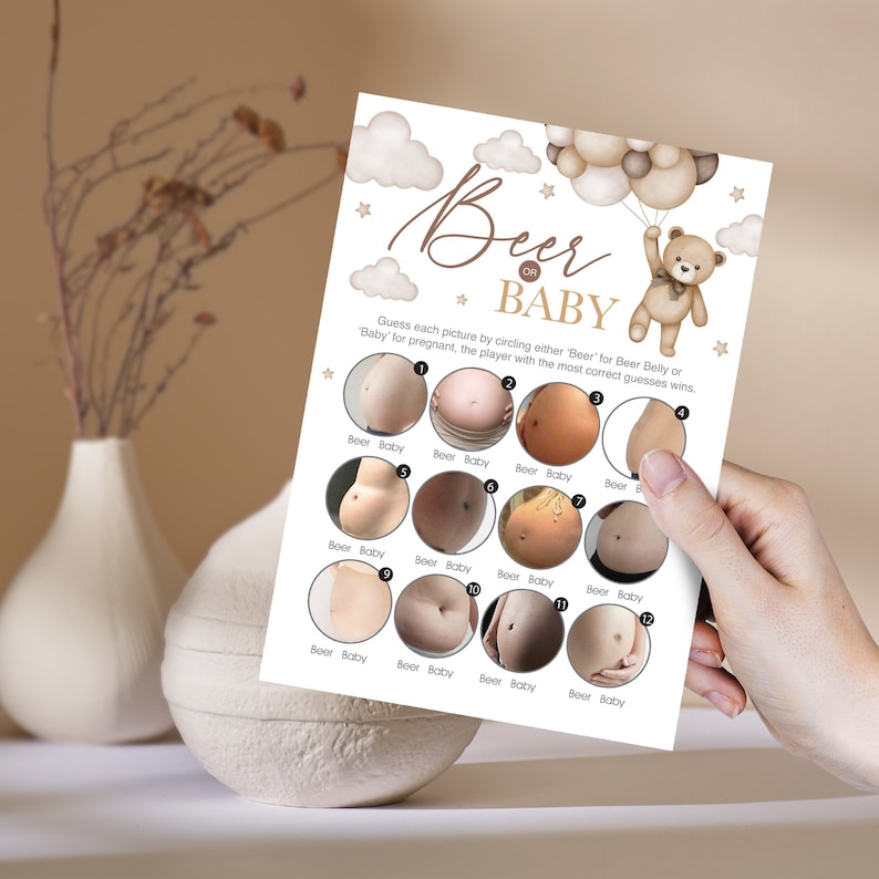 May include: A game card with 12 images of pregnant bellies and beer bellies. The card asks players to guess which is which. The text on the card reads "Beer or Baby".