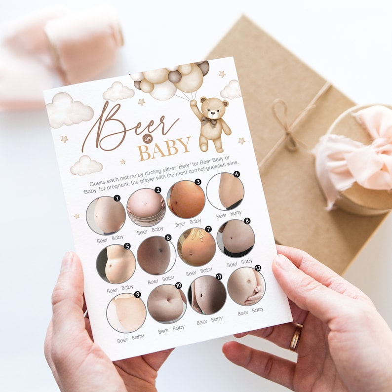 May include: A printable game card for a baby shower party. The card has a brown teddy bear holding balloons and the text "Beer or Baby". There are 12 images of pregnant bellies and the player must guess if it is a beer belly or a baby bump.
