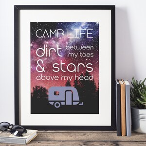 May include: A framed print with a galaxy background and the text "Camplife: dirt between my toes & stars above my head". A silhouette of a camper van is at the bottom of the print.