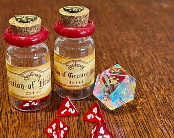 May include: Two small glass bottles with cork stoppers and red labels. The labels read "Apothecary Potion of Health 2D4 +2" and "Apothecary Potion of Greater Health 4D4 +4".  A clear iridescent 20-sided die with red and gold numbers is in the foreground.