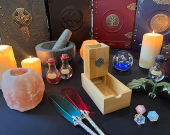 May include: A collection of fantasy-themed items, including potion bottles labeled "Healing" and "Mana", a wooden dice tower, and a crystal ball with blue accents. Other items include candles, a mortar and pestle, and decorative books.